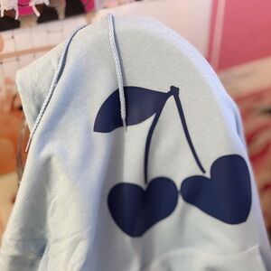 Sweetheart Cherries Hoodie – Light Blue Pullover with Heart-Shaped Cherry Graphi